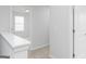Upstairs hallway with white trim and doors, neutral carpet, and natural light entering from the nearby window at 407 Newland Way, Acworth, GA 30102