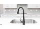 Close up view of the kitchen faucet and white quartz countertop at 407 Newland Way, Acworth, GA 30102