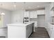Kitchen island with white countertop and black faucet in modern open kitchen at 407 Newland Way, Acworth, GA 30102