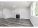 Bright living room with fireplace, grey flooring and double hung window at 407 Newland Way, Acworth, GA 30102