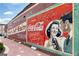 Exterior shot of a brick wall with vintage Coca-Cola mural, featuring a couple at 407 Newland Way, Acworth, GA 30102