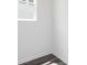 Bright, empty room showcasing wood-look flooring, white walls, and a window with natural light at 407 Newland Way, Acworth, GA 30102