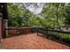 Elevated outdoor deck with black railings offering expansive views of the backyard at 1772 Martin Se Pl, Smyrna, GA 30080