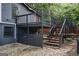 Exterior two-story deck with black railings and stained steps leading to backyard at 1772 Martin Se Pl, Smyrna, GA 30080