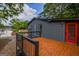 Spacious outdoor deck with black railing and red door overlooking the property at 1772 Martin Se Pl, Smyrna, GA 30080