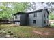 Charming backyard featuring a spacious deck, stone patio, and lush greenery, perfect for outdoor entertaining at 1772 Martin Se Pl, Smyrna, GA 30080