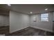 Finished basement with modern gray wood-look floors and bright white walls at 1772 Martin Se Pl, Smyrna, GA 30080