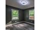 Light-filled bedroom with views from two windows and neutral walls at 1772 Martin Se Pl, Smyrna, GA 30080