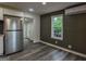 Updated kitchen featuring stainless steel refrigerator, modern cabinets, and hardwood-style flooring at 1772 Martin Se Pl, Smyrna, GA 30080