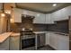 Modern kitchen with updated appliances, countertops, and stylish hanging light fixture at 1772 Martin Se Pl, Smyrna, GA 30080