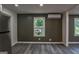 Bright living room with hardwood floors, large windows, and modern lighting fixture at 1772 Martin Se Pl, Smyrna, GA 30080