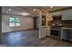 Bright, open-concept space with a kitchen, stainless appliances, and stylish flooring at 1772 Martin Se Pl, Smyrna, GA 30080