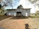 Backyard view of the home with deck, patio and mature trees at 2860 Lynda Pl, Decatur, GA 30032
