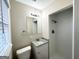 Renovated bathroom with a granite vanity, new toilet, and a walk-in shower with white tiled walls at 2860 Lynda Pl, Decatur, GA 30032