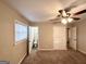 Cozy bedroom with carpeted floors, a ceiling fan, and a glimpse into an attached bathroom at 2860 Lynda Pl, Decatur, GA 30032