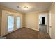 Bedroom with carpeting, glass patio doors and an attached bathroom at 2860 Lynda Pl, Decatur, GA 30032