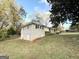 Side view of brick home with large lot and mature trees under partly cloudy skies at 2860 Lynda Pl, Decatur, GA 30032