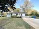 Charming single-story home with a gray brick facade, manicured lawn, and a long, paved driveway at 2860 Lynda Pl, Decatur, GA 30032