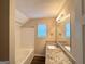 This renovated bathroom has a granite countertop, new fixtures, and a shower/tub combination at 614 Tramore Ct, Stockbridge, GA 30281