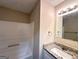 Bathroom featuring granite countertops, white cabinets, a tub, and light fixtures at 614 Tramore Ct, Stockbridge, GA 30281