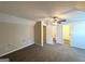 The neutral bedroom has plush carpeting, neutral walls, and a ceiling fan at 614 Tramore Ct, Stockbridge, GA 30281