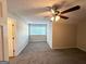 This bedroom features neutral walls, plush carpeting, and a ceiling fan at 614 Tramore Ct, Stockbridge, GA 30281