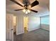 This bedroom has plush carpeting, neutral walls, a ceiling fan, and easy access to the bathroom at 614 Tramore Ct, Stockbridge, GA 30281