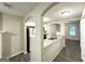 Open kitchen view featuring stainless steel appliances, granite countertops, and hardwood floors at 614 Tramore Ct, Stockbridge, GA 30281