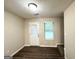 Bedroom view with hardwood floors, a rear window and access to the backyard at 614 Tramore Ct, Stockbridge, GA 30281