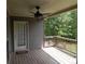 Relaxing back porch shows backyard views, ceiling fan, and convenient door access at 141 Windward Hills, Mcdonough, GA 30253