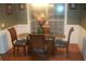Dining room featuring a glass table with wood chairs and a decorative vase at 141 Windward Hills, Mcdonough, GA 30253