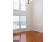 Dining room featuring large windows, hardwood floors, and classic wainscoting, perfect for entertaining guests at 141 Windward Hills, Mcdonough, GA 30253
