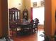 Elegant dining room featuring a wooden table set, china cabinet, and large windows for natural light at 141 Windward Hills, Mcdonough, GA 30253