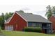 Exterior view of home with gray roof, brick and gray siding, and a backyard at 141 Windward Hills, Mcdonough, GA 30253