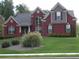 Charming brick two-story home with a well-manicured front yard and classic architectural details at 141 Windward Hills, Mcdonough, GA 30253