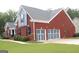 Two-story brick home with attached two-car garage, landscaped yard, and charming curb appeal at 141 Windward Hills, Mcdonough, GA 30253