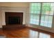 Traditional brick fireplace and large window, creating a cozy and inviting room at 141 Windward Hills, Mcdonough, GA 30253