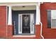 Inviting front entry with a charming wreath, brick accents, and a 'Welcome' sign at 141 Windward Hills, Mcdonough, GA 30253