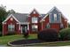 Charming two-story red brick home with manicured lawn and mature landscaping, creating inviting curb appeal at 141 Windward Hills, Mcdonough, GA 30253
