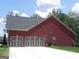 Three-car garage showcases ample parking and brick facade at 141 Windward Hills, Mcdonough, GA 30253