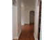 Hallway with hardwood floors, arched openings, and access to multiple rooms at 141 Windward Hills, Mcdonough, GA 30253