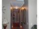 Inviting hallway featuring hardwood floors, neutral walls, arched entryways, and elegant lighting at 141 Windward Hills, Mcdonough, GA 30253