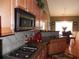 Modern kitchen with granite countertops, stainless appliances, and a gas cooktop for gourmet cooking at 141 Windward Hills, Mcdonough, GA 30253