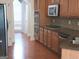 Kitchen featuring stainless steel appliances, wood cabinets, granite countertops, and hardwood floors at 141 Windward Hills, Mcdonough, GA 30253