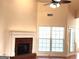 Cozy living room featuring a brick fireplace, large windows, and ample natural light at 141 Windward Hills, Mcdonough, GA 30253