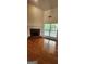 Inviting living space with fireplace, wood floors, and a large window, creating a warm and inviting ambiance at 141 Windward Hills, Mcdonough, GA 30253