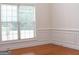 Cozy and bright living room features wainscoting detail and large window at 141 Windward Hills, Mcdonough, GA 30253