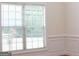 Bright living room featuring a large window with blinds and custom trim work at 141 Windward Hills, Mcdonough, GA 30253