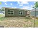 Exterior view of home featuring an ample backyard with green grass and rear patio at 385 Orchard Land, Covington, GA 30014