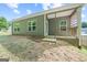 Exterior view of home showcasing the backyard area with a patio at 385 Orchard Land, Covington, GA 30014
